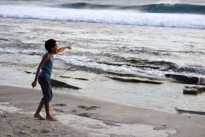 France, Reunion island (French overseas department), South coast, petite île, Grande Anse beach, child pointing out at a wave
