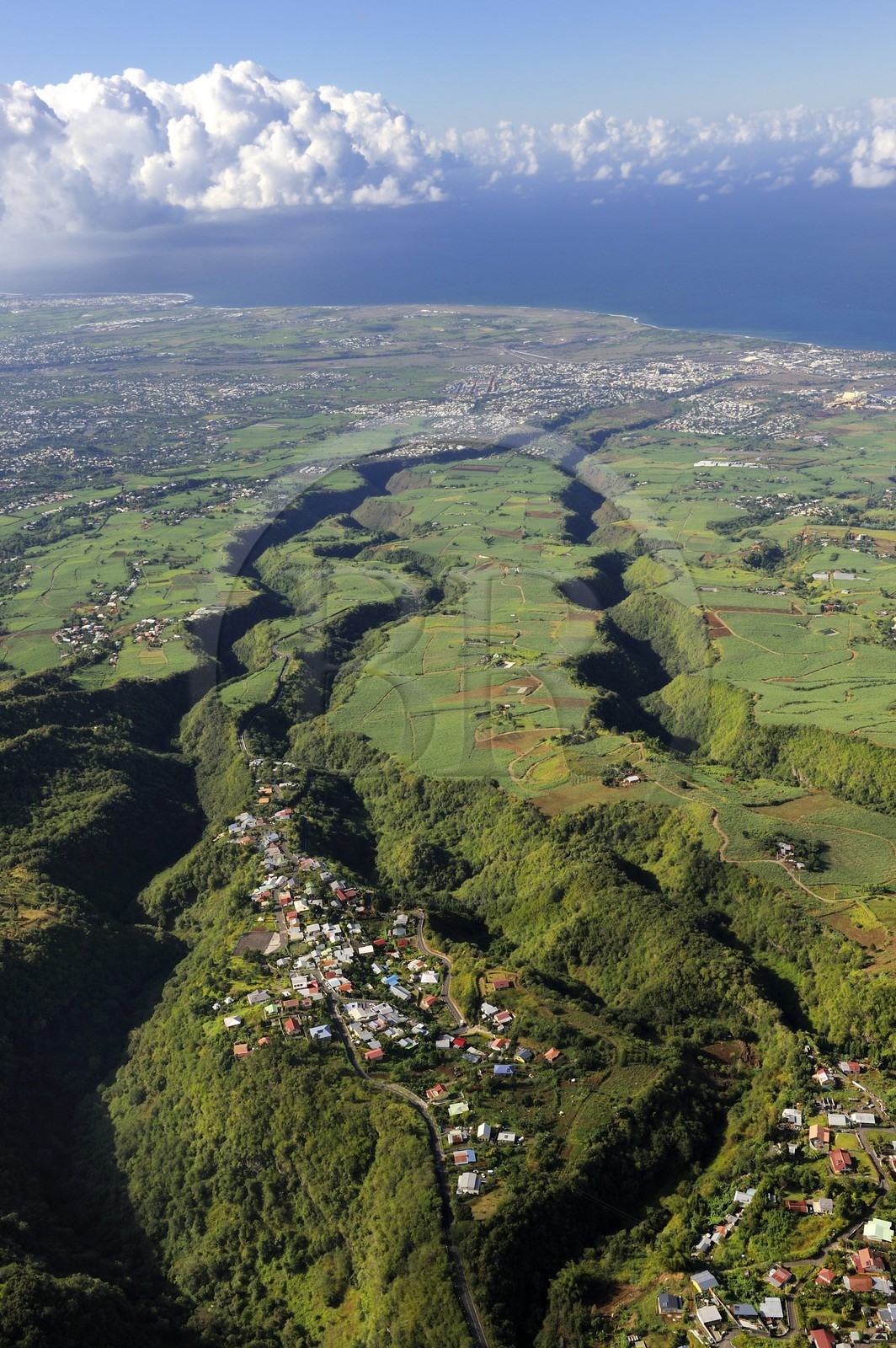 France, Reunion island (French overseas department), village Les Makes and the West coast towards St. Louis in the background (aerial view)