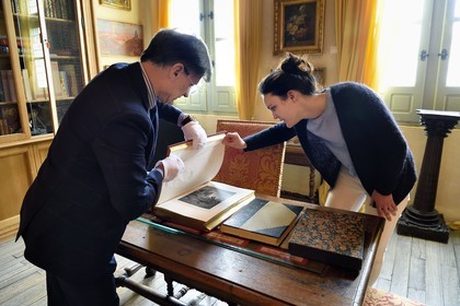 France, Aisne, Château-Thierry, Jean de La Fontaine Museum - city of Chateau-Thierry, the director of the museum pole Nicolas Rousseau and his deputy director Marie-Mileva Pavlovitch observing the La Fontaine's Fables book, illustrated edition (1867, in-folio) by Gustave Doré