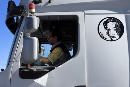 Iran, Yazd province, Dasht-e Kavir desert, Kharanaq, truck cab adorned with the trucker's wife portrait