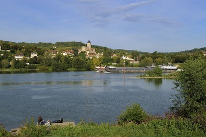 France, Val-d'Oise, a barge on the Seine river in front of Vetheuil and its Notre Dame church painted by Claude Monet