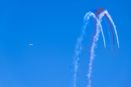 France, Bouches du Rhone, Salon de Provence, air base 701, base of the Patrouille de France (PAF for Patrouille acrobatique de France) of the French Air and Space Force, Alphajet planes fly in Rafale formation performing a loop, an airliner flies in the sky in the background