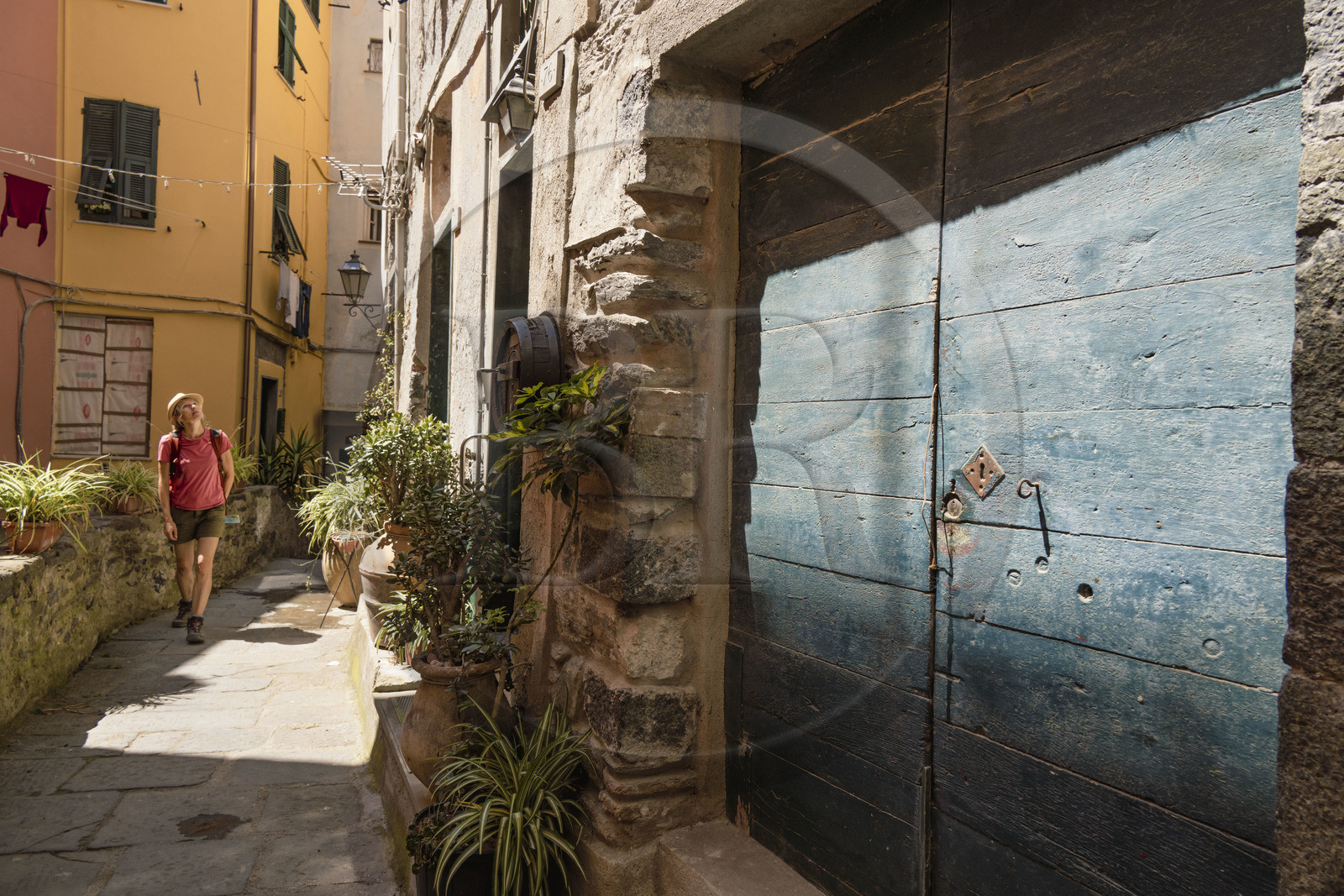 Italy, Liguria, Cinque Terre National Park listed as World Heritage by UNESCO, hiker crossing the village of Vernazza