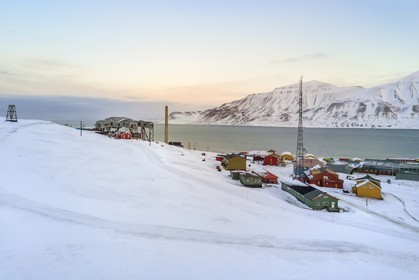 Norway, Svalbard, Spitzbergen, Longyearbyen, Taubanesentralen on the left, abandoned central cableway building used for transporting coal in carts from the mines to the harbour (aerial view)