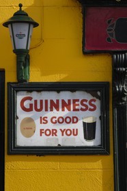 Republic of Ireland, County Kildare, Naas, old adverts on a pub 's wall