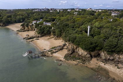 France, Loire Atlantique, Estuaire de la Loire, Saint Nazaire, the Feu de Porcé (lighthouse) along the GR 34 long-distance trail, alignment lights which serve to mark the maritime channel allowing entry into the Loire estuary and  traditional carrelet (fishing shack) on the beach