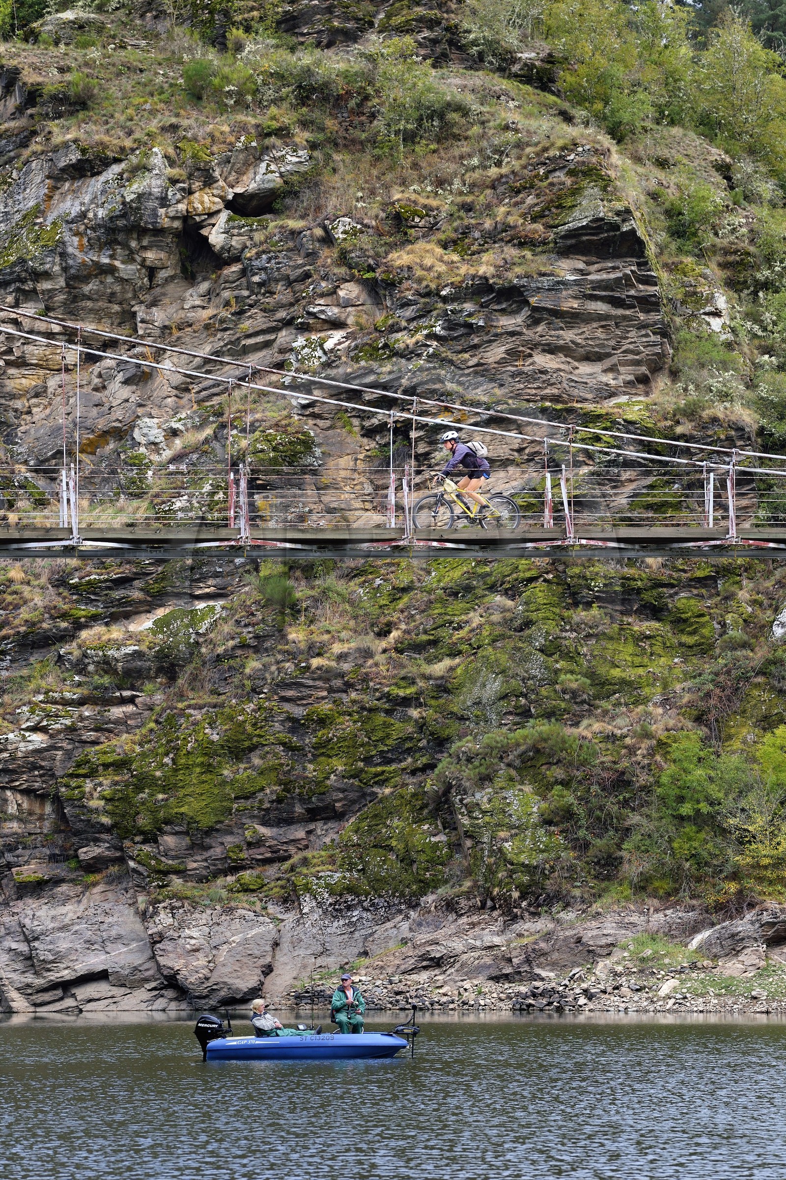 France, Cantal, Gorges de la Truyere (Truyere river canyon), Chaliers, anglers on their boat under the Valadour footbridge over the Truyère river