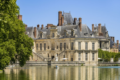 France, Seine-et-Marne, Fontainebleau, castle of Fontainebleau listed as World Heritage by UNESCO, the Belle Cheminée wing and its monumental staircase overlooking the Cour de la Fontaine, the carp pond in the foreground