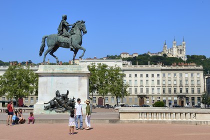 France, Rhone, Lyon, historical site listed as World Heritage by UNESCO, equestrian statue of louis XIV on place Bellecour and Notre Dame de Fourviere in the background
