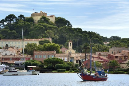 France, Var, Iles d'Hyeres, Parc National de Port Cros (National park of Port Cros), Porquerolles island, Bernard Samuel called Sam the fisherman on his boat called Le Corailleur leaving the Porquerolles port overlooked by the Sainte-Agathe Fort