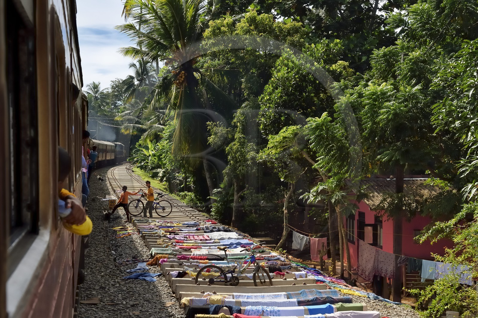 Sri Lanka, Western Province, train from Colombo to Galle, laundry drying on the railway under construction towards Kalutara