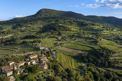 France, Vaucluse, Dentelles de Montmirail mountains, the village of Suzette surrounded by the vineyard and the summit of the Saint Amand ridge in the background (aerial view)