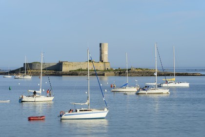 France, Finistere, La Foret Fouesnant, Glenan islands, St Nicolas Island, boats at anchor and Fort Cigogne on Cigogne Island in the background