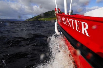 United Kingdom, Scotland, Highlands, Loch Ness, the boat Nessie Hunter sailing towards Urquhart castle