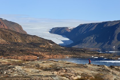 Greenland, North West coast, Smith sound north of Baffin Bay, Inglefield Land, hiking on Etah site in Foulke fjord, today abandoned Inuit camp that served as a base for several polar expeditions, Brother John's Glacier and the ice cap in the background
