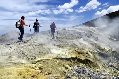 Italy, Sicily, Aeolian Islands, listed as World Heritage by UNESCO, Vulcano Island, hikers climbing the crater of volcano della Fossa through sulfur fumaroles