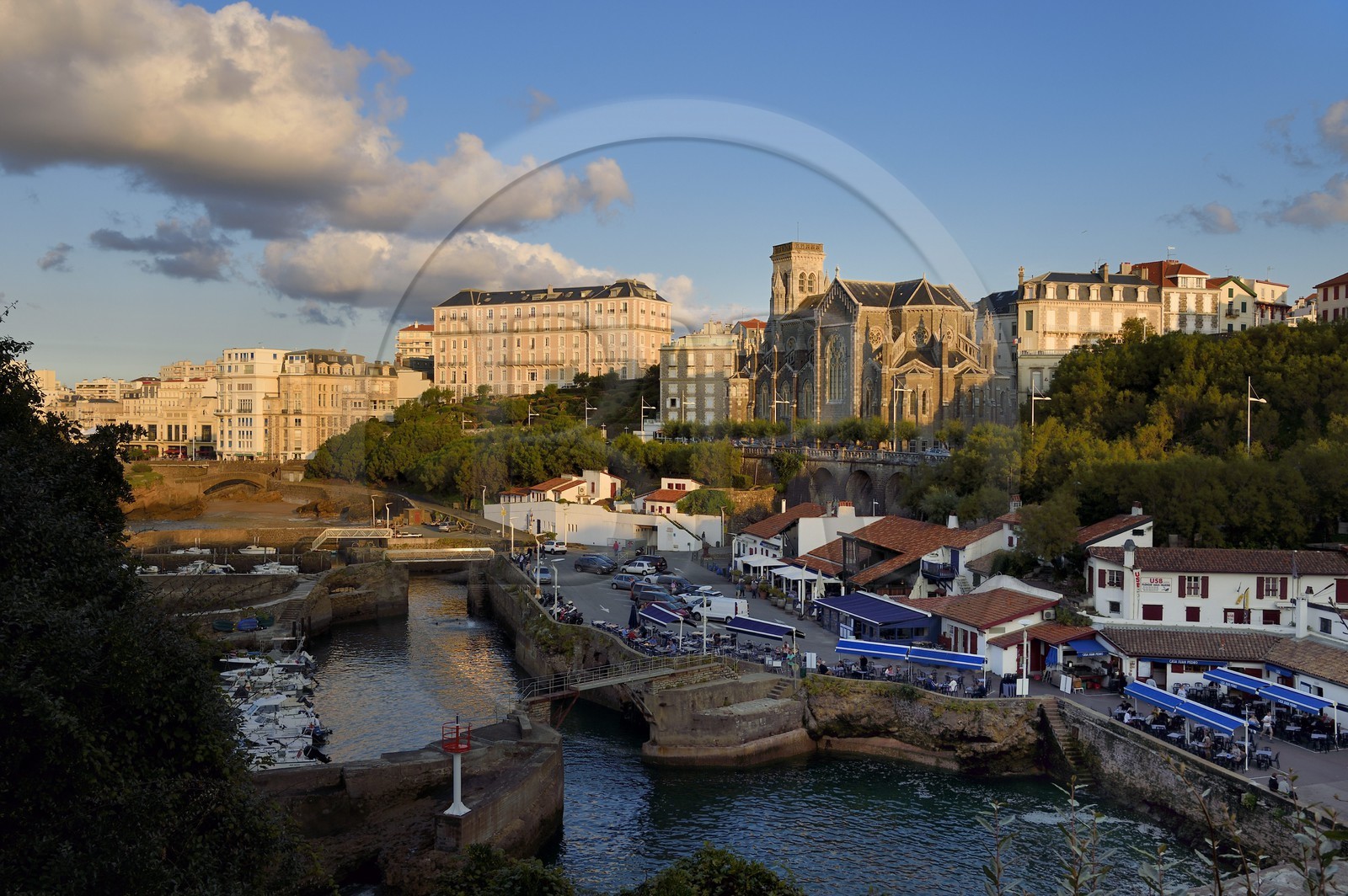 France, Pyrenees Atlantiques, Basque Country, Biarritz, Port des Pecheurs, Sainte Eugenie church and facades of the buildings located on Grande Plage (Great beach)