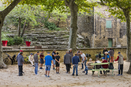 France, Gard, Vers Pont du Gard, petanque players on the village square which is on the path along the route of the Roman aqueduct of Nimes