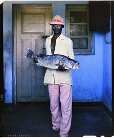 Burundi, Rumonge Province, young Hutu fisher who shows a Capitaine likely a Nile perch (Lates niloticus) (4x5 reversal film reproduction)