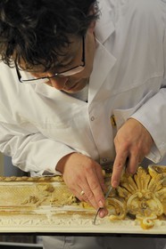 France, Yvelines, Chateau de Versailles, the castle restoration workshop, gilt workshop, Laurent Hissier working on a frame