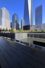 United States, New York,  Manhattan, 9 11 Memorial designed by Israeli architect Michael Arad involving a forest of trees around two bodies of water with two large Square holes in their center at the exact spot where the formers towers stood and the engraved names of victims, the One World Trade Center (1WTC) in the background