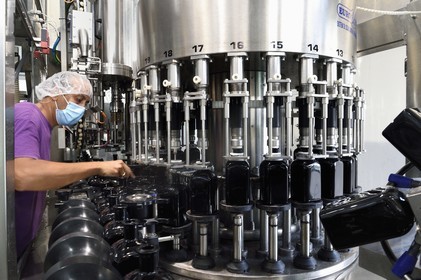 France, Reunion island (French overseas department), Saint Pierre, estate of the Isautier distillery, bottling and labeling plant, bottling of 70cl of rum arranged, line conductor Khaldu Boualem