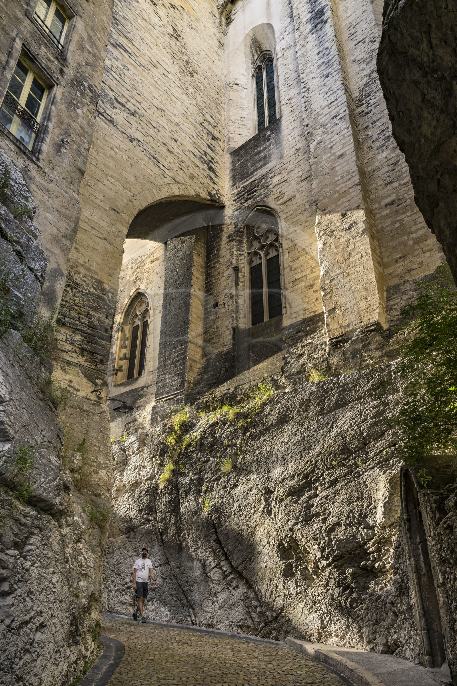 France, Vaucluse, Avignon, the rue de la Peyrolerie, a passage dug into the rock at the foot of the Palais des Papes (Palace of the Popes) classified as UNESCO World Heritage