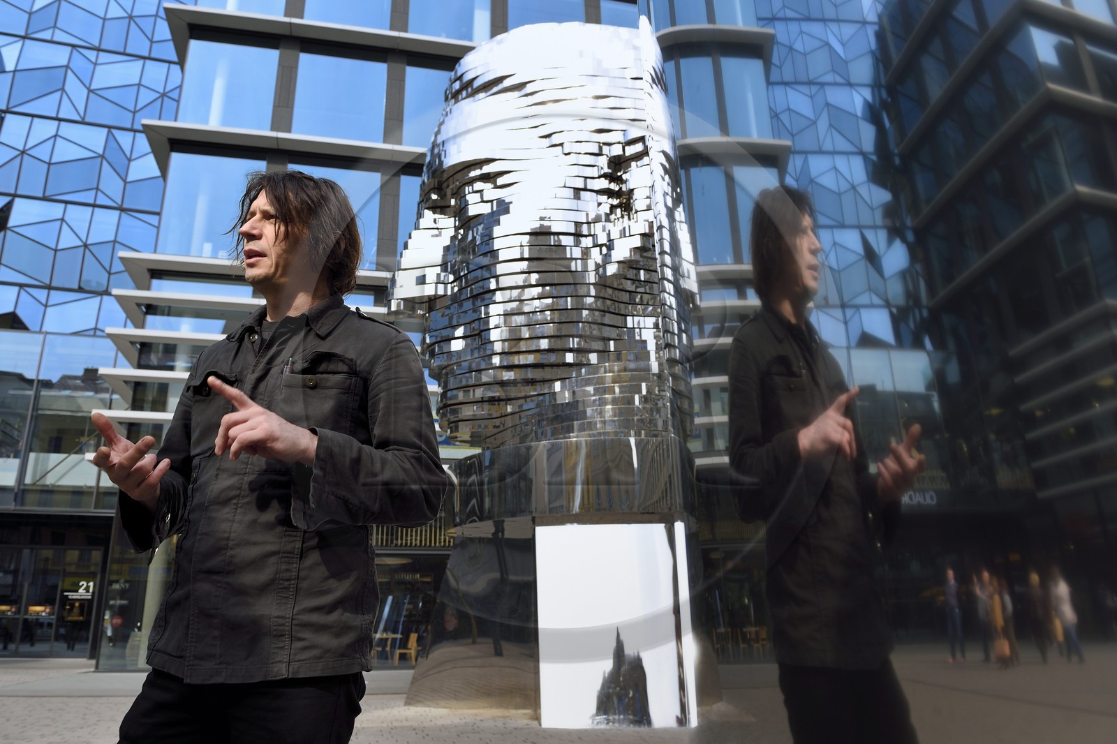 Czech Republic, Prague, Nove Mesto, artist David Cerny posing in front of his work Franz Kafka head, a mechanical statue