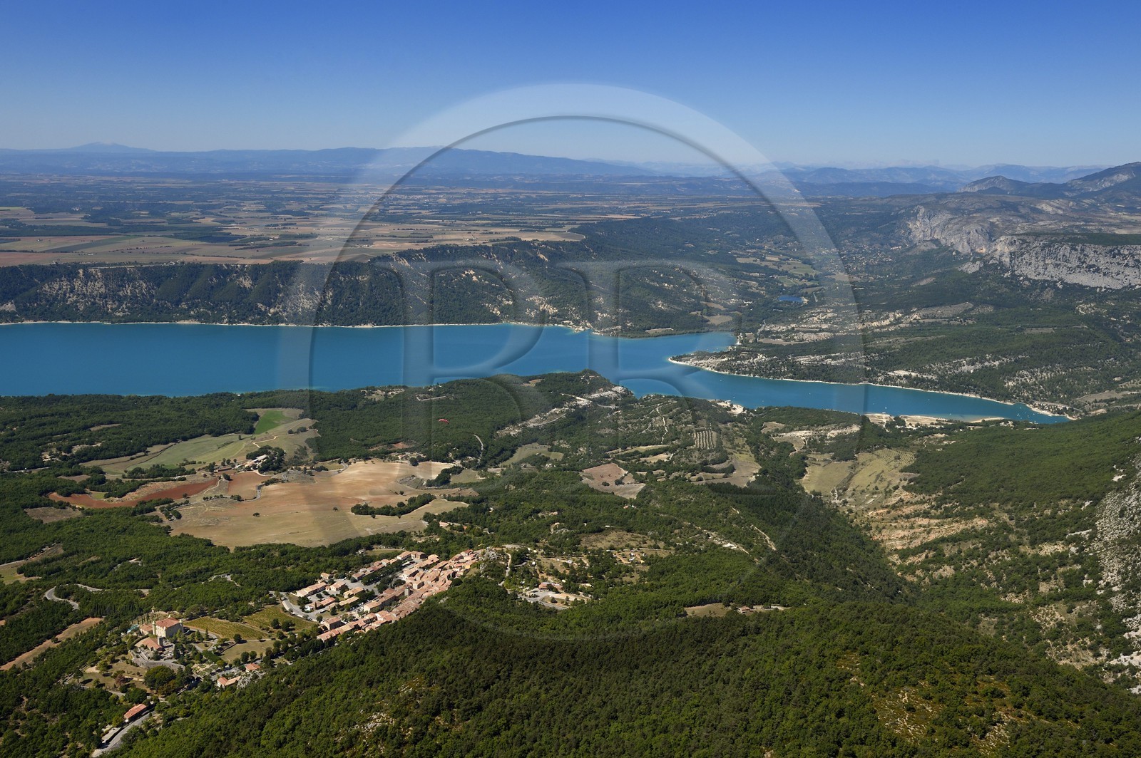 Var on the Left Bank and Alpes de Haute Provence on the Right Bank, Parc Naturel Regional du Verdon, Lake St Croix at the exit of the Gorges du Verdon, in the foreground the Renaissance castle of Aiguines and the St. John's Church (aerial view)