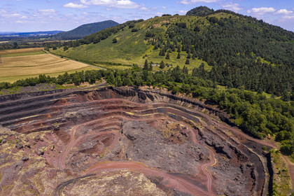 France, Puy de Dome, Parc Naturel Régional des Volcans d'Auvergne (regional nature park of Auvergne volcanoes), Chaine des Puys listed as World heritage by UNESCO, Saint Ours les Roches, Lemptegy volcano, a former pozzolan quarry that has become an educational site open to the public, the Puys Chopine and the Gouttes in the background (aerial view)