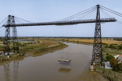 France, Charente Maritime, Rochefort, the Rochefort (or Martrou) transporter bridge built by Ferdinand Arnodin in 1900, the nacelle is in translation above the Charente river (aerial view)
