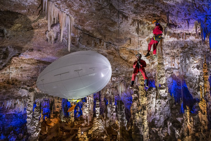 France, Gard, Mejannes-le-Clap, grotte de La Salamandre (Salamander cave), abseiling and discovery of the cave in Aéroplume®, an individual dirigible balloon inflated with helium which allows you to fly away by flapping your wings