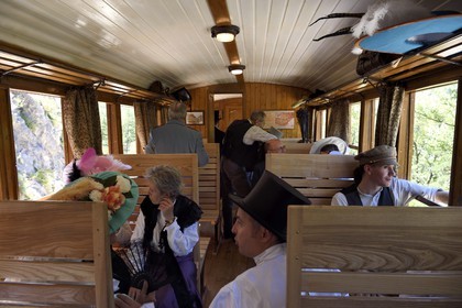 France, Alpes de Haute Provence, between Annot and Saint-Benoit, Train des Pignes historic train, members of the AHVAE (Association d'histoire vivante et de d'archeologie expérimentale) in Belle Epoque costume in a passenger car from 1892