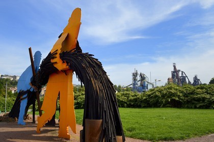 France, Moselle, Fensch Valley, Hayange, Luc Mercier sculpture with the last Blast furnaces (known as of Florange) of ArcelorMittal in the background