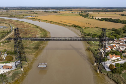France, Charente Maritime, Rochefort, the Rochefort (or Martrou) transporter bridge built by Ferdinand Arnodin in 1900, the nacelle is in translation above the Charente river (aerial view)
