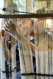 France, Rhone, Lyon, La Croix Rousse District, Silk manufacturer Prelle, silk loom developed by Joseph Marie Jacquard called Jacquard loom, the canut (lyonnais silk worker) Sebastien preparing his loom