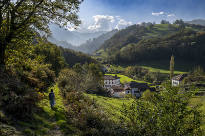 France, Pyrenees Atlantiques, Basque Country, Aldudes valley, hiker on a trail leading to the village of Urepel