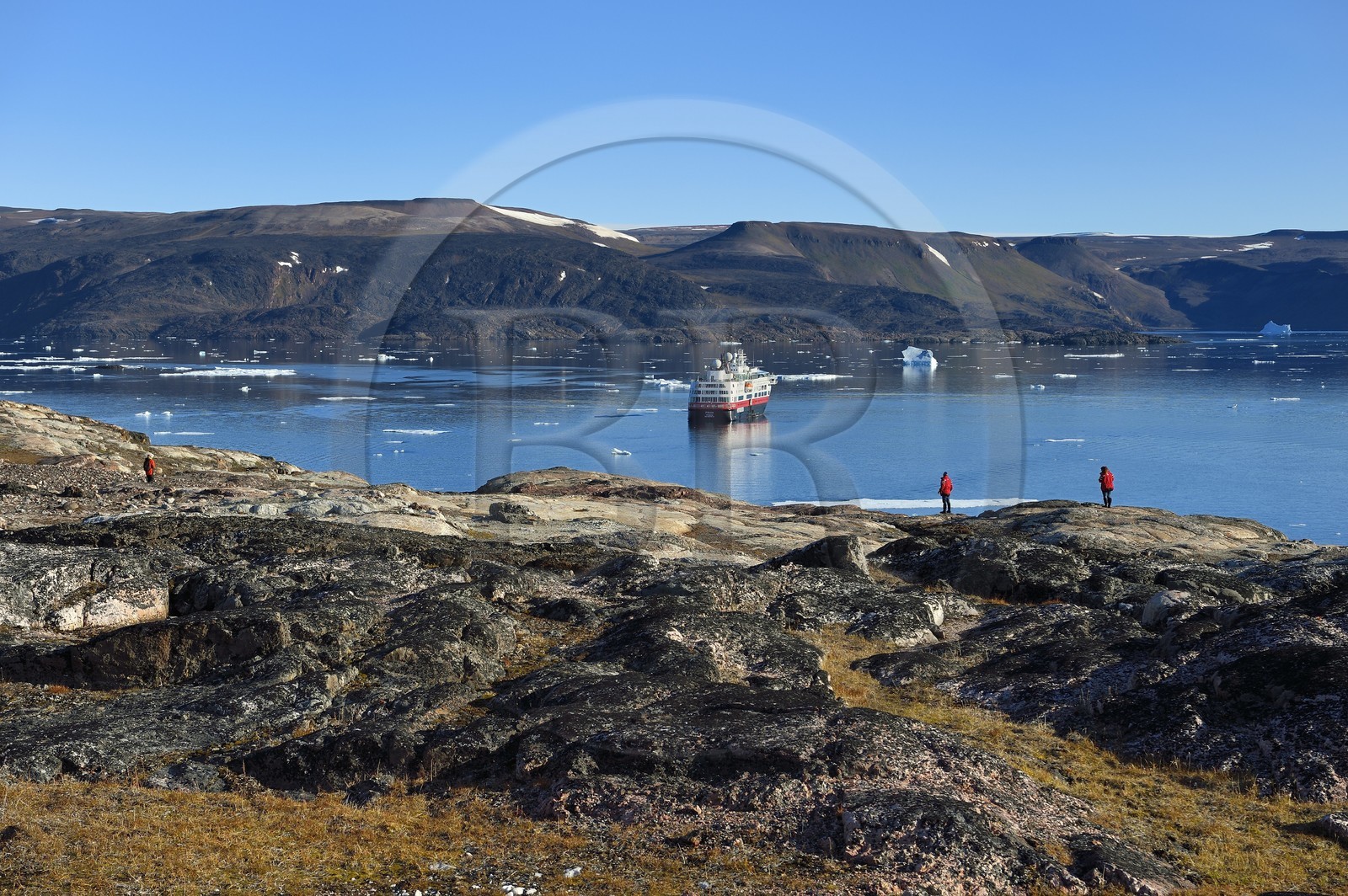Greenland, North West coast, Smith sound north of Baffin Bay, Inglefield Land, hiking on Etah site in Foulke fjord, today abandoned Inuit camp that served as a base for several polar expeditions, Hurtigruten's MS Fram cruise ship in the background