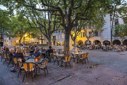 France, Gard, Uzès, the Place aux Herbes surrounded by houses with arcades and its café terraces