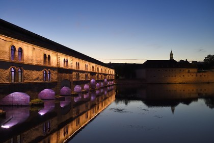 France, Bas Rhin, Strasbourg, old town listed as World Heritage by UNESCO, la Petite France District, Vauban dam over the Ill river and the ENA (National School of Administration) in the former Commandery Saint John right, illuminations in the evening