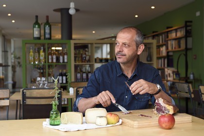 France, Corse du Sud, Prunelli river valley, Bastelica, Boutique Hotel Artemisia, its director Christophe Gandon taste a country ham together with local produce, apple, goat and sheep cheese