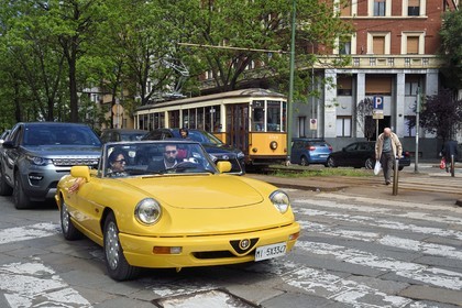 Italy, Lombardy, Milan, Alfa Romeo Duetto Spider yellow cabriolet in the streets of the city