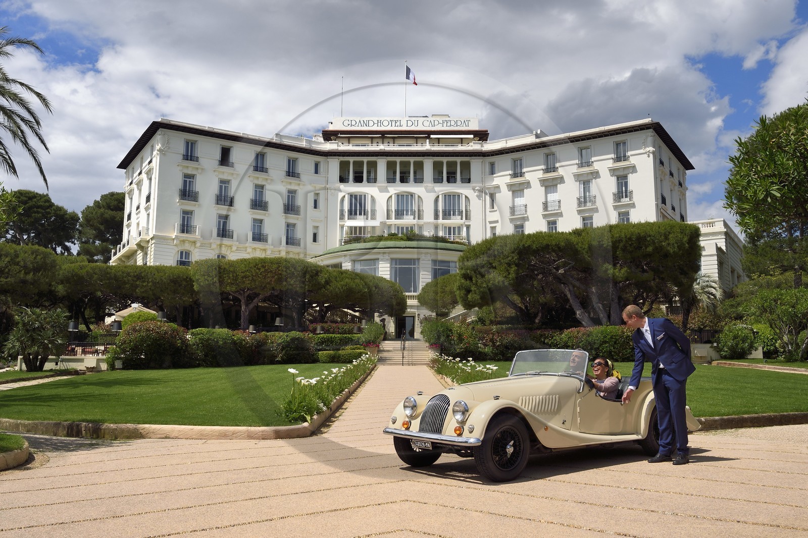 France, Alpes Maritimes, Saint Jean Cap Ferrat, Grand-Hotel du Cap Ferrat, a 5 star palace from Four Seasons Hotel, the doorman welcomes customers in a Morgan Roadster 4 4