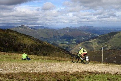 Spain, Basque Country, Navarra, Camino de Santiago (the Way of St. James) between Saint Jean Pied de Port and Roncesvalles, hikers at the Lepoeder pass and the Valley of Luzaide in the background
