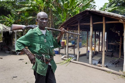 Gabon, Ogooue-Maritime Province, Omboue region, Nengeue Sika (Silver island) in the Fernan Vaz (Nkomi) lagoon, man leaving for hunting with his gun