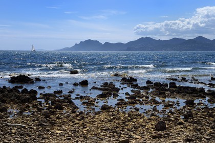 France, Alpes-Maritimes, Lerins Islands, sailboat off the Sainte-Marguerite island and the Esterel Mountains in the background