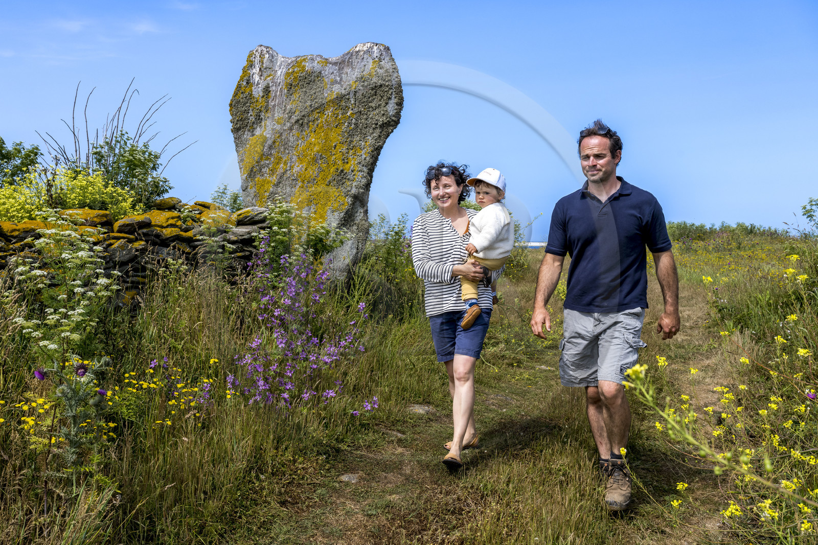 France, Finistère (29), Mer d'Iroise, archipel de Molène, Ile de Quéménès, ferme de Quéménès bio et autonome en énergie, les agriculteurs Amélie Goossens et Etienne Menguy à côté du menhir