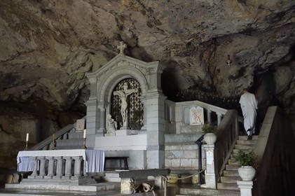 France, Var, Plan d'Aups Sainte Baume, Sainte-Baume Regional Nature Park, Sainte Baume massif, the cave sanctuary of Sainte Marie-Madeleine (St. Mary Magdalene), a monk climbs up to the reliquary of Mary Magdalene behind the altar