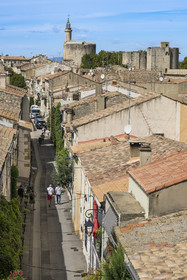 France, Gard, Aigues Mortes, street of the old town from the ramparts and the Tower of Constance in the background