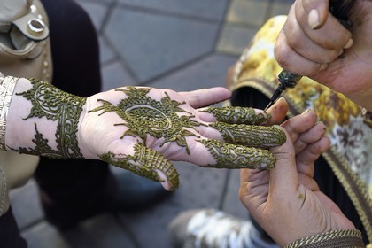 Morocco, High Atlas, Marrakech, Imperial city, Medina listed as World Heritage by UNESCO, Jemaa El Fna square, henna tattoos on a hand